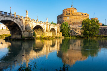 Obraz premium Castle of Holy Angel (Castel Sant'Angelo) and St. Angel bridge (Ponte Sant'Angelo) over Tiber river in Rome, Italy