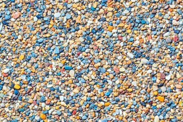 Close-up view of colorful small stones covering a surface. Seamless pattern.