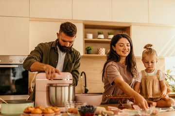 Family baking together in modern home kitchen