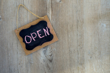 Open for Business Message Witten on Small Chalkboard on Wood Background