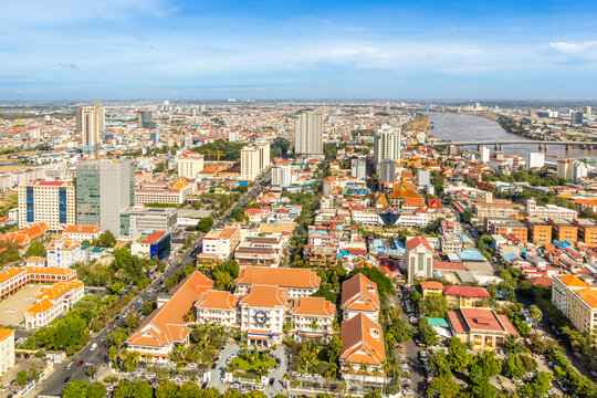 Modern residential areas and office buildings with Tonle Sap river in the background in rapidly developing Phnom Penh city panorama, Cambodia
