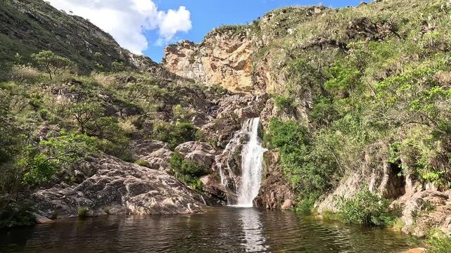 Serra do Cip&oacute; Waterfall on a Beautiful Clear Sky Day with White Clouds