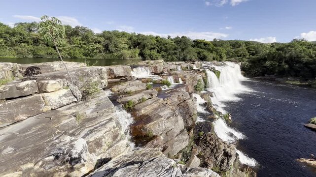 Serra do Cip&oacute; Waterfall on a Beautiful Clear Sky Day with White Clouds