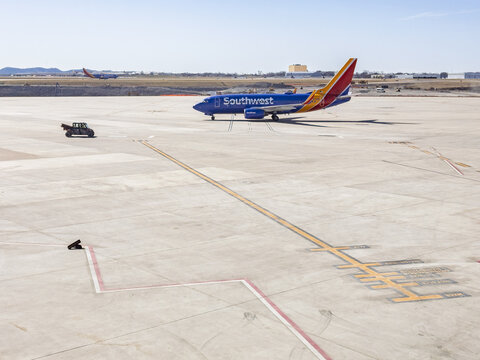 A Southwest Airlines airplane on the tarmac at Nashville International Airport (BNA) in Nashville, TN. It&rsquo;s going to the runway. Another Southwest Airlines airplane is in the runway.