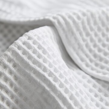 Cotton waffle weave, honeycomb pattern texture, white bathrobe fabric macro