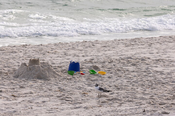 Sandcastles and Beach Toys on Gulf Shores Beach in Alabama During a Sunny Day by the Ocean