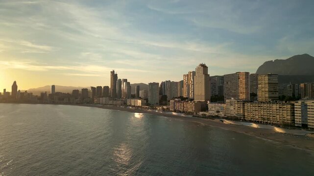 Golden sunset aerial view of benidorm city skyline and beach