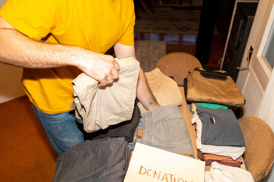 Sorting Clothing for Donation at Home During Daylight Hours