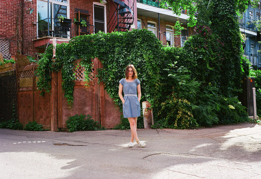 Woman Standing in front of vines