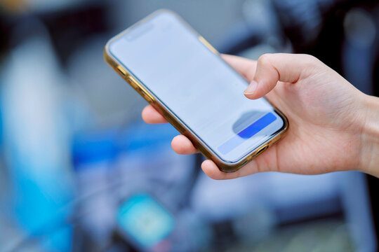 Hand Holding Smartphone in Outdoor Setting While Texting