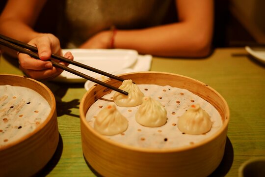 Dumplings Being Served in a Bamboo Steamer at a Cozy Restaurant