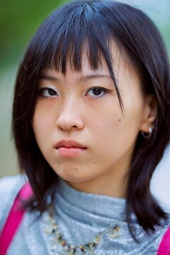 Portrait of a Young Woman With a Serious Expression Outdoors