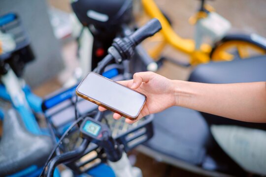 Woman on Phone Before Riding a City Shared Bicycle