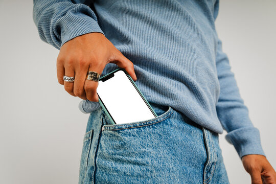 Anonymous man takes phone out of his pocket with blank screen