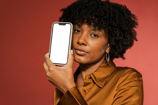 Woman with a smartphone whit blank screen in studio