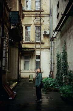 a woman walking in the city on a rainy day