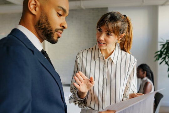 Business colleagues collaborating on documents in an office setting