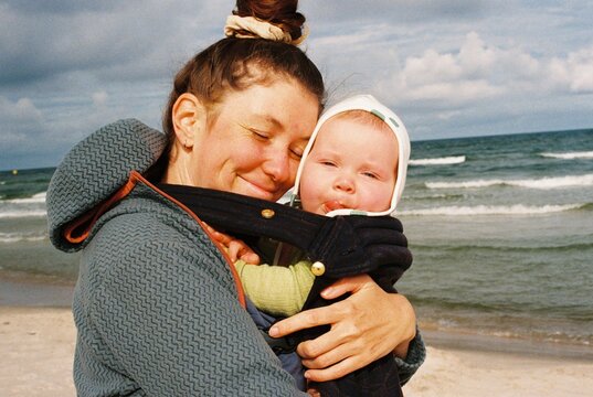 Happy mother and her baby opposite the Baltic sea