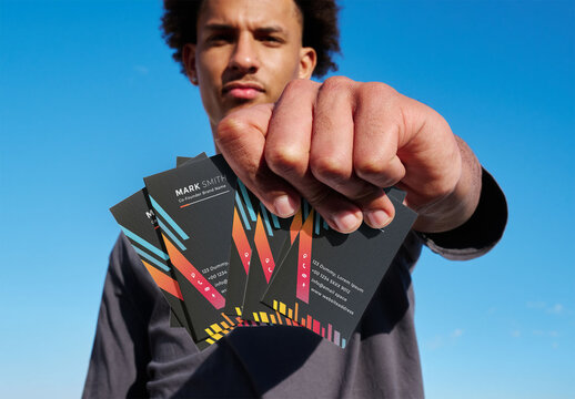 Real photo of bunch of Business Cards Mockup Held by man. PSD mockup
