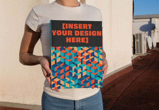 Real photo of  a Blank Book cover Held by anonymous woman. PSD mockup