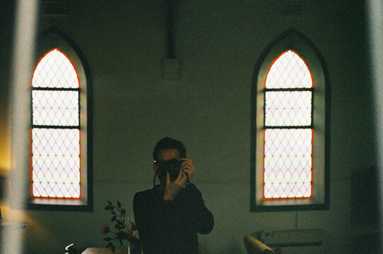 Film photo of a Self-Portrait in Reflection with Stained Glass Light