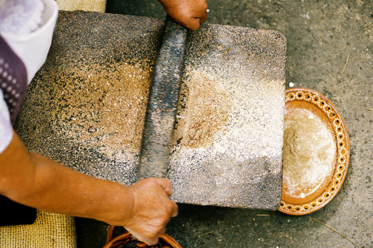 Film photo of Grinding Ingredients on a Traditional metate