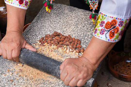 Traditional stone grinding with almonds and tools