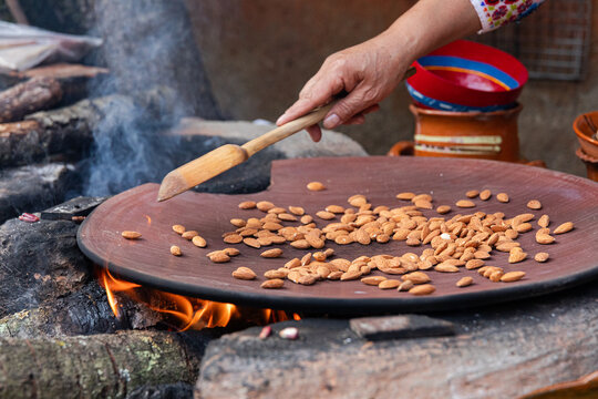 Roasting almonds in a comal in a Mexican Kitchen