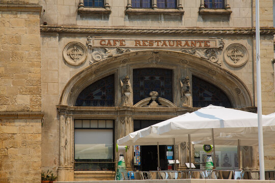 Ornate facade of the cafe restaurant Santa Cruz, historical portuguese style building in Praca 8 de Maio town square, Coimbra, Portugal