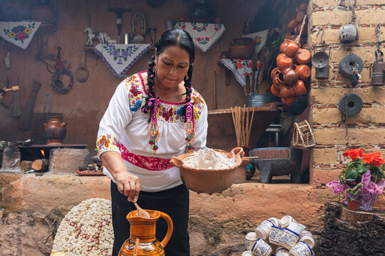 Woman preparing corn flour with rustic kitchen backdrop