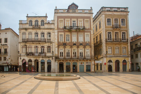 Facade of ornate historical portuguese style buildings in Praca 8 de Maio town square, Coimbra, Portugal