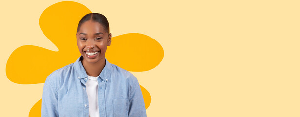 A woman stands in front of a bright yellow background smiling. She wears a light blue shirt and seems happy. This collage captures her joyful expression and playful design. © Prostock-studio