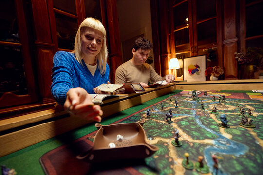 Woman rolls dice during the game
