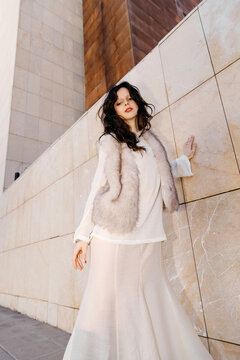 Woman outdoors wearing fur vest 