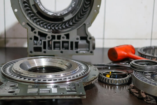 Inner view of a heavy-duty Allison transmission retarder housing showing the intricate stator vanes and hydraulic channels on a workshop table for professional maintenance and repair.