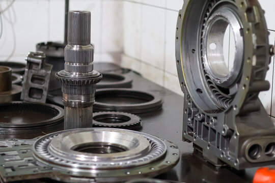 Inner view of a heavy-duty Allison transmission retarder housing showing the intricate stator vanes and hydraulic channels on a workshop table for professional maintenance and repair.