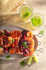 Tasty grilled skewer made of mediterranean seafood.