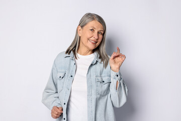 Portrait of beautiful senior woman on light background