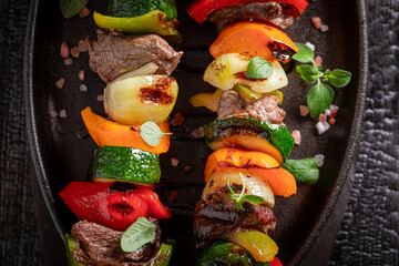 Hot roasted skewer made on a metal grill.