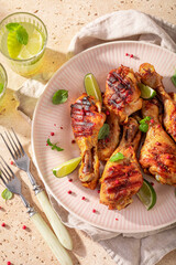 Crispy grilled chicken leg made on a metal grill.