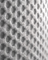 Obraz premium Textile surface with sensory texture and friendly pattern creates modern workspace atmosphere, featuring soft hexagonal shapes and subtle light for calming effect