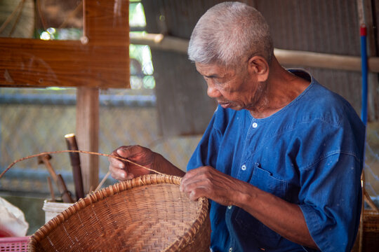 Senior artisan weaving traditional bamboo basket