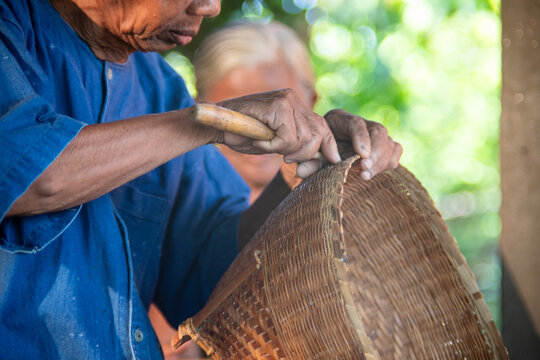Senior artisan weaving traditional bamboo basket