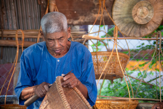 Senior artisan weaving traditional bamboo basket