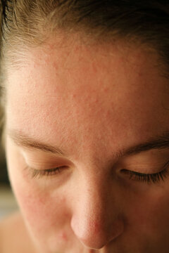 Close-up of a Woman's Serene Expression in Soft Natural Light
