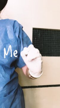 Doctor researcher in protective suit studying measles virus writing hand in Mexico, lock down camera