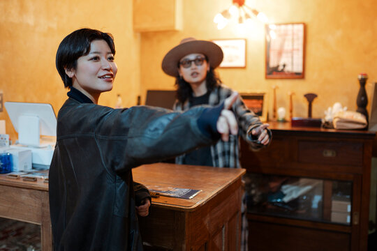 Female customer pointing in a clothing store in Japan