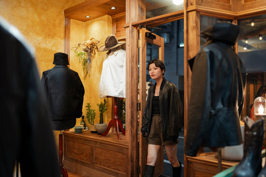 Woman entering boutique clothing store in Tokyo Japan