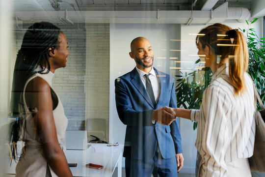 Business professionals shaking hands forming new agreement
