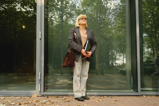 Business Attire in Urban Setting With Laptop and Stylish Accessories